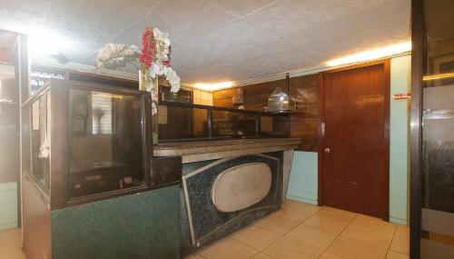 a living room with a tv in a room at RedDoorz at Maanyag Pension House Mandaue in Cebu City