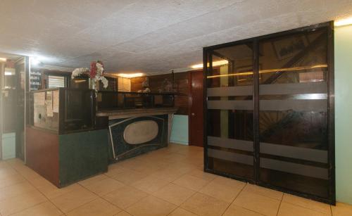 a room with a room with a tv in it at RedDoorz at Maanyag Pension House Mandaue in Cebu City