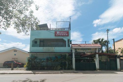 a building with a sign on top of it at RedDoorz at Maanyag Pension House Mandaue in Cebu City