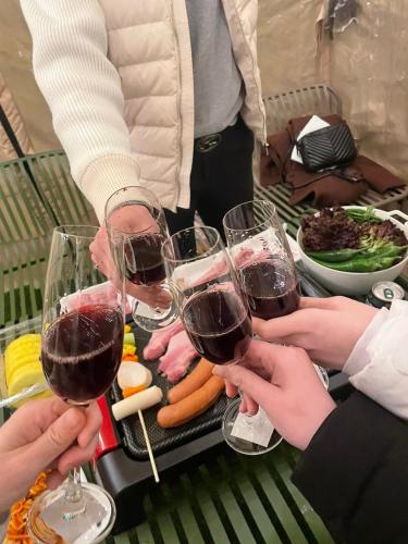 a group of people holding up glasses of wine at ADO hotel in Seoul