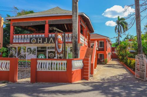 a building with an orange fence in front of it at Paradise On The Rocks Hotel in Negril