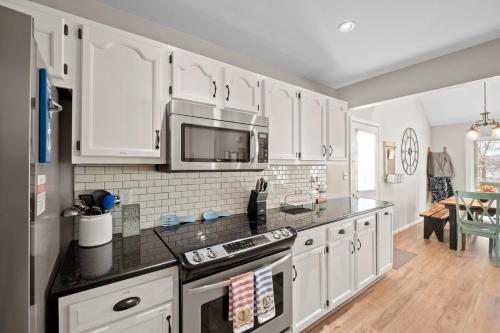 a kitchen with white cabinets and a microwave at High Rock Haven in Lexington