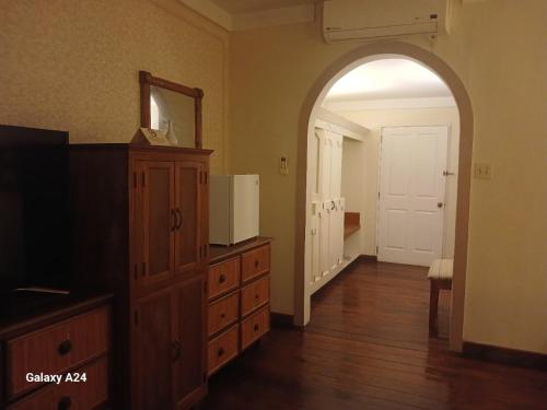 a room with a dresser and a mirror and a door at Yap Pacific Dive Resort in Yaptown