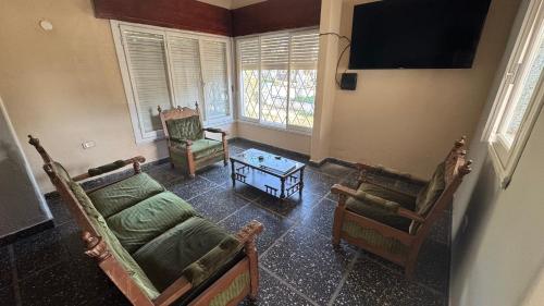 サンタ・ロサ・デ・カラムチタにあるLa casa de Renaのリビングルーム(椅子2脚、ソファ、テレビ付)