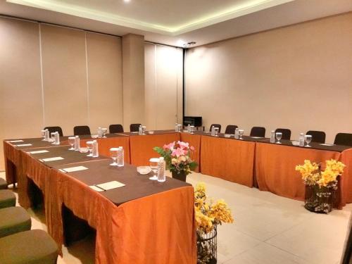 a conference room with a long table and chairs at Moscato Hotel in Lembang