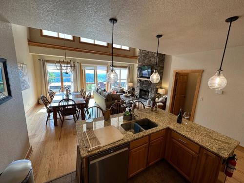 a kitchen with a sink and a living room at Appalachian Hideaway in Mars Hill