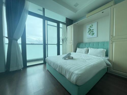 a bedroom with a large bed with a large window at Riverson Soho Luxury Stay by Finest Homestay in Kota Kinabalu