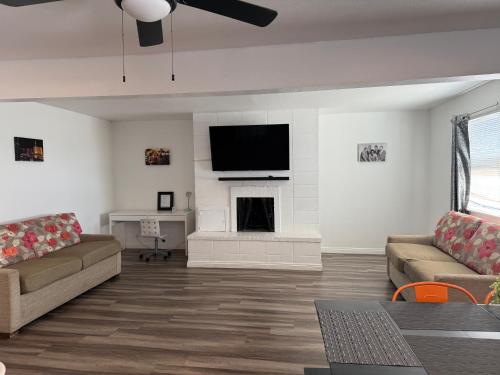 a living room with a couch and a fireplace at Vegas Super Central 2 Min to LV Strip in Las Vegas