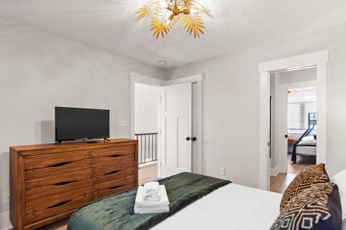a bedroom with a bed and a television on a dresser at Waterfront Treehouse on the Cape Fear with Dock in Rocky Point