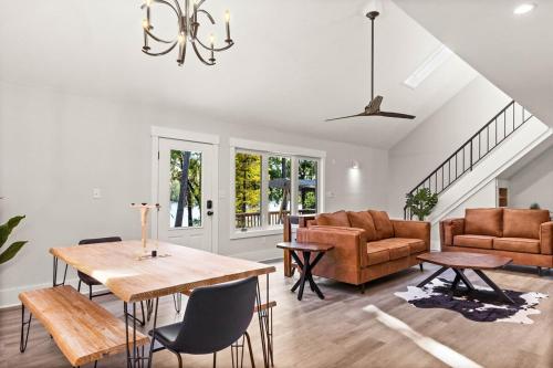 a living room with a wooden table and chairs at Waterfront Treehouse on the Cape Fear with Dock in Rocky Point