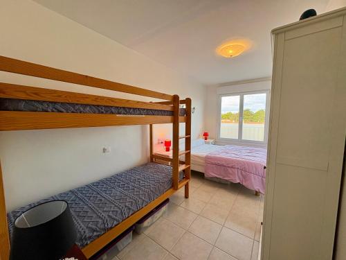 une chambre avec deux lits superposés et une fenêtre dans l'établissement Charmant T2 rénové avec balcon et vue mer à Saint Jean de Monts - FR-1-323-319, à Saint-Jean-de-Monts