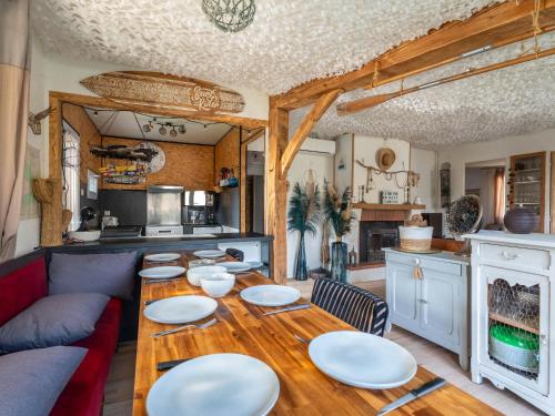 d'une salle à manger avec une table recouverte de plaques blanches. dans l'établissement Maison à Biscarrosse: 8 pers, piscine, clim, proche lac et pistes cyclables, ménage inclus - FR-1-319-538, à Biscarrosse