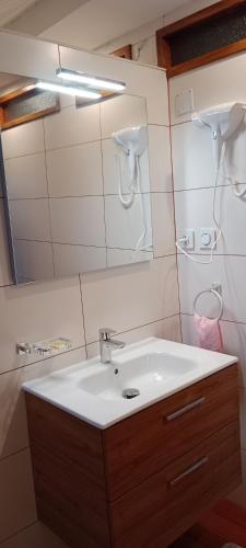 a bathroom with a white sink and a mirror at Chambre d'Hôte Villa Maritampona in Antsirabe