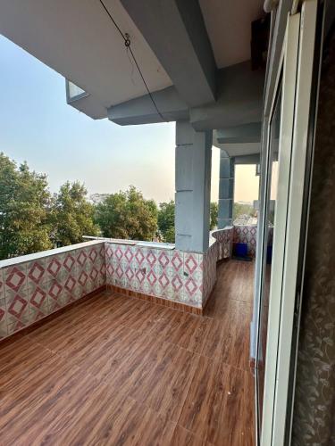 a balcony with a wooden floor and a view at Talupula Beach View Homestay in Jalāripeta