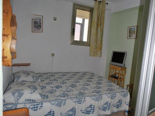 une chambre avec un lit, une fenêtre et une télévision dans l'établissement Le Lavandou T2 Cabine 4 personnes, à 10m de la plage avec parking - FR-1-803-90, au Lavandou