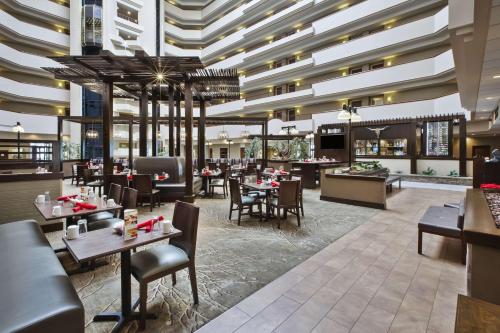 a restaurant with tables and chairs and a large ceiling at DoubleTree by Hilton Rapid City Downtown Convention Center in Rapid City