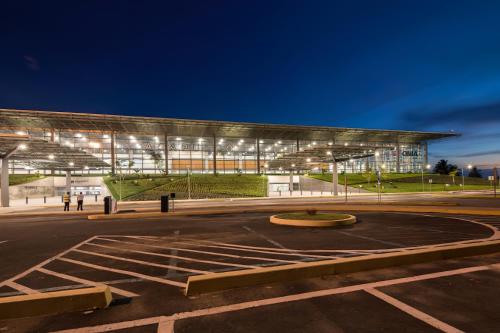 a lit up building with a fountain in a parking lot at Alberca, Playa Cercana & Club de Playa opcional -Departamento E13D302 in Gallinero