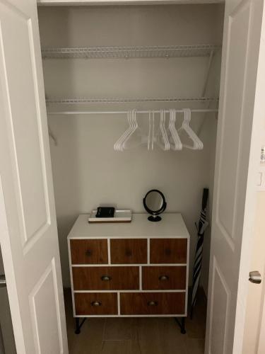 a bedroom with a dresser and a drawer with a scale on it at Seas the Day TCI -Sonos, Covered Balcony, hot tub in Wheeland Settlement