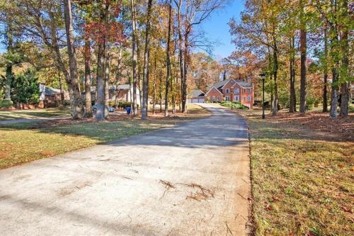 an empty road in a residential neighborhood with trees at Star Mansion Atlanta in Atlanta
