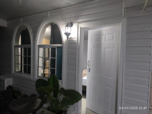 a white door in a room with a window at SWEET BREEZE in San Andrés