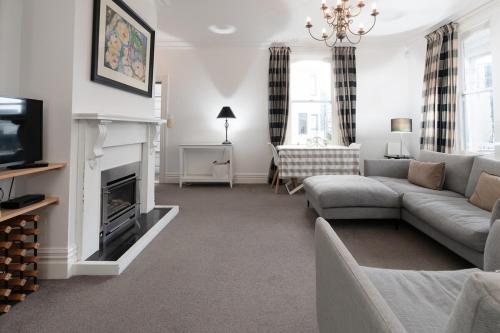 a living room with a couch and a fireplace at A Central City Historic Escape in Wellington
