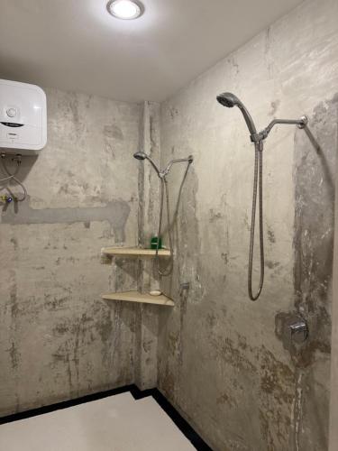 a bathroom with a shower and a sink at Uluwatu Stay's Deluxe Suite #9 in Uluwatu