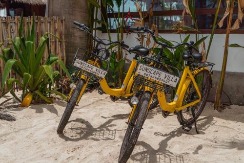 two bikes parked in the sand on the beach at Sunscape Villa - Beachfront and private pool in Gili Air