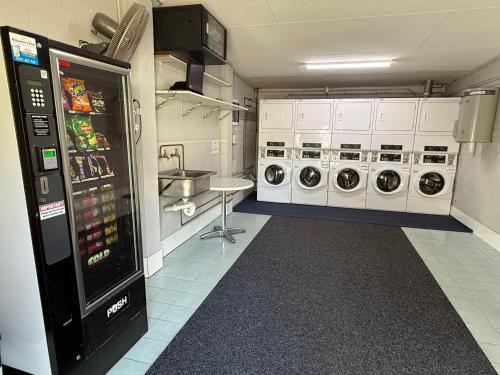 a laundry room with a washer and dryer at Geraldton Motor Inn in Geraldton