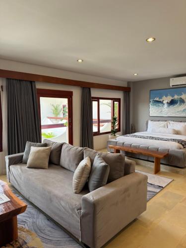 a living room with a couch and a bed at Uluwatu Stay's Deluxe Suite #5 in Uluwatu