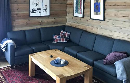 a living room with a blue couch and a coffee table at Pet Friendly Home In Hovden I Setesdal in Hovden