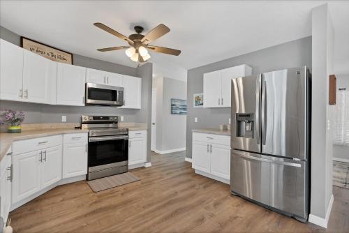 a kitchen with white cabinets and a stainless steel refrigerator at DBD1014 in Port Charlotte