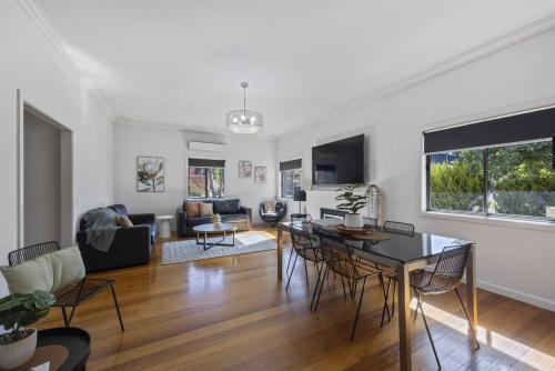 a living room with a table and chairs at Bendigo Signature Accommodation on Chapel in Bendigo