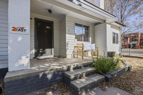 a front porch of a white house with a door at Bendigo Signature Accommodation on Chapel in Bendigo