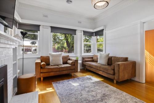 a living room with two chairs and a couch at Bendigo Signature Accommodation on Hargreaves in Bendigo