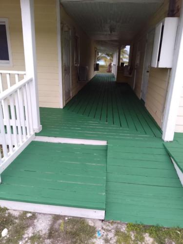 a porch with green flooring on a house at Alvira's Place in Mars Bay