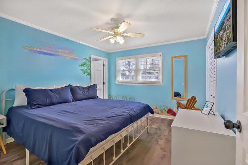 a blue bedroom with a bed and a ceiling fan at A Shore Thing in North Myrtle Beach! 4 Bedroom Home! in Myrtle Beach