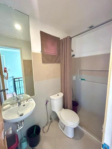 a bathroom with a toilet and a sink at VIP 4-Bedroom House in Butuan