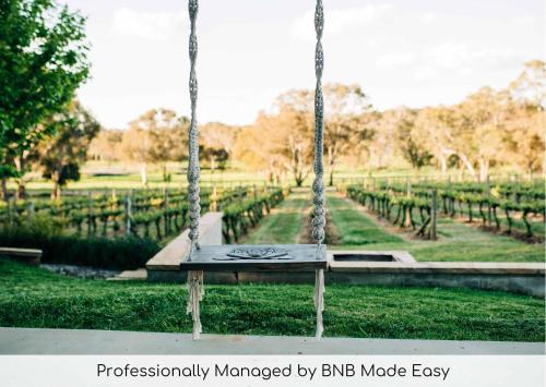 a swing in the middle of a park at Mortimer's Wines Studio - Adults Only Retreat in Orange