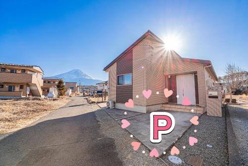 a house with pink hearts on the side of it at New Open! Collab House 富士山眺望 送迎無料 BBQ 器具無料貸出 in Fujikawaguchiko
