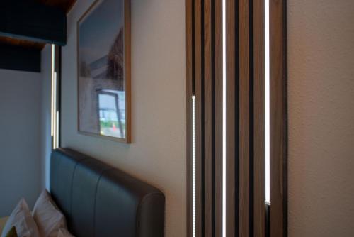 a room with a chair and a picture on the wall at Wylie Court Motor Lodge in Rotorua