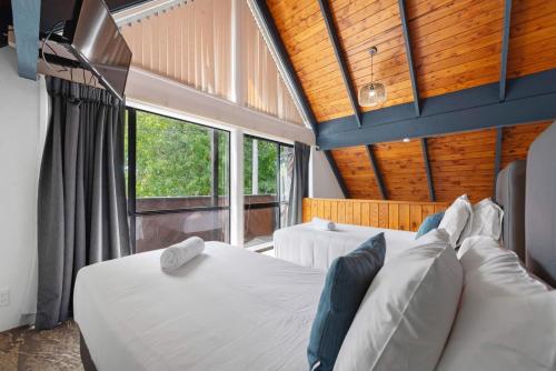 a bedroom with two beds and a large window at Wylie Court Motor Lodge in Rotorua
