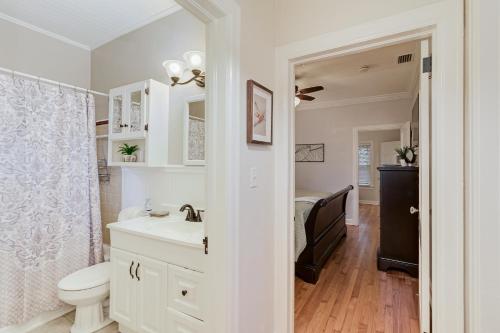 a white bathroom with a sink and a toilet at Vistabula Historic Cottage - Walk to FSC & Downtown Lakeland in Lakeland