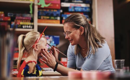 a woman brushing a little girls face in a store at Precise Resort Rügen Apartments & SPLASH Erlebniswelt in Sagard