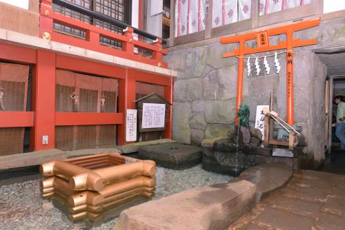 an entrance to a building with an orange gate and a building with at Togakubo in Isehara