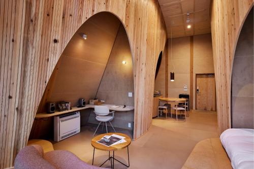 an archway in a room with a table and chairs at SANU 2nd Home 軽井沢1st in Oiwake
