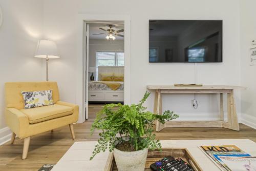 a living room with a chair and a table at Pennsylvania Bungalow - Historic Home in Downtown Lakeland in Lakeland