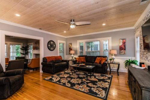 a living room with a couch and a table at The Osceola Historic District Charm - 10 Minute Walk to FSC & Downtown Lakeland in Lakeland