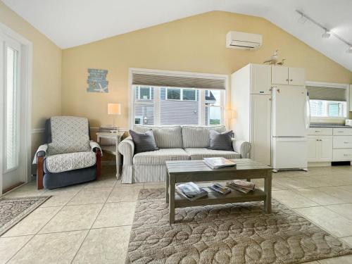 a living room with a couch and a refrigerator at Seascapes W153 Fantastic condo steps away from Wells Beach and town center 1900 in Wells