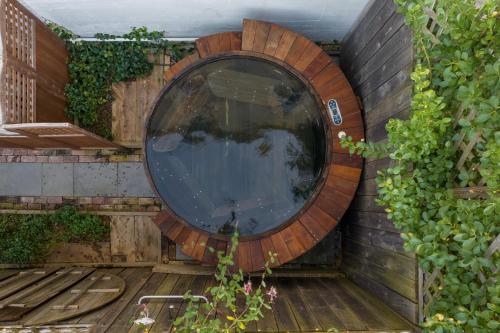 a circular window on the side of a wall at Palazzo Hudson - Luxury Pool, Hot Tub, and Sauna in Hudson