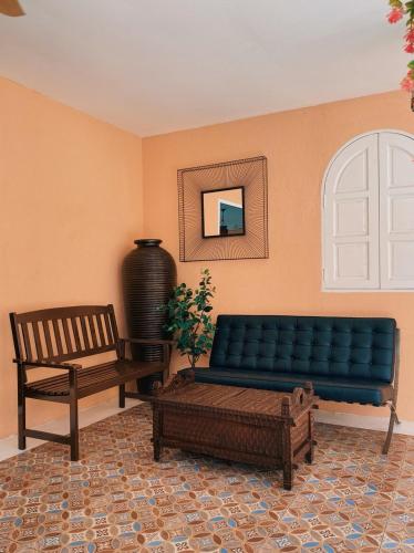 a living room with a blue couch and a bench at Villa Sajuri Homestay Sg Sembilang in Jeram